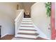 Elegant staircase with hardwood steps and white risers, leading to the upper level of the home at 2577 Abbotts Glen Nw Dr, Acworth, GA 30101