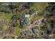 Aerial view of the home with a green roof in a wooded neighborhood at 3107 Hendrix Circle Sw, Covington, GA 30014