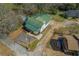 Aerial view of the property featuring a white house with a green roof at 3107 Hendrix Circle Sw, Covington, GA 30014