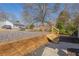 Backyard featuring a retaining wall, fresh gravel and convenient access stairs at 3107 Hendrix Circle Sw, Covington, GA 30014