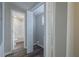 Modern bathroom with a shower-tub combo and access to laundry area at 3107 Hendrix Circle Sw, Covington, GA 30014