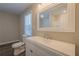 Bathroom shows modern vanity, toilet, and window for natural light at 3107 Hendrix Circle Sw, Covington, GA 30014
