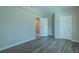 Bright bedroom with wood-look flooring, ample closet space, and vaulted ceiling at 3107 Hendrix Circle Sw, Covington, GA 30014