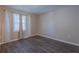 Bedroom shows bright window with decorative curtains, hardwood floors at 3107 Hendrix Circle Sw, Covington, GA 30014