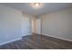 Spacious bedroom with wood-look flooring, neutral walls, and large closet at 3107 Hendrix Circle Sw, Covington, GA 30014