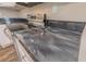 Dark countertop with stainless steel range in the kitchen with stainless steel hardware at 3107 Hendrix Circle Sw, Covington, GA 30014