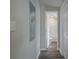 Hallway with wood-look floors leads to a bathroom with a white toilet and tub at 3107 Hendrix Circle Sw, Covington, GA 30014