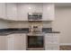 White kitchen cabinets with dark countertops, open view of the stainless steel oven at 3107 Hendrix Circle Sw, Covington, GA 30014