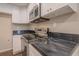 Updated kitchen with stainless steel oven and range with dark countertops and white cabinets at 3107 Hendrix Circle Sw, Covington, GA 30014
