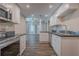 Bright modern kitchen features white cabinetry, dark countertops, and open floorplan at 3107 Hendrix Circle Sw, Covington, GA 30014