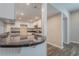 Bright eat-in kitchen with white cabinets, black countertops, and modern fixtures at 3107 Hendrix Circle Sw, Covington, GA 30014