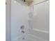 Detail of the white shower with chrome fixtures and built-in shelves at 3107 Hendrix Circle Sw, Covington, GA 30014