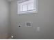 Wall with outlet, electrical connections, and small window with blinds at 3107 Hendrix Circle Sw, Covington, GA 30014