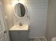 Bathroom featuring modern vanity, designer mirror, and stylish patterned tile at 4664 Ryan Rd, Conley, GA 30288