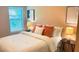 Inviting bedroom with warm hues, comfortable bedding, bedside tables, and artistic accents at 473 Broder Farms Dr, Stockbridge, GA 30281
