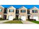 Charming townhome with brick facade, black shutters, well-maintained landscaping and driveways at 473 Broder Farms Dr, Stockbridge, GA 30281