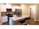 Well-equipped kitchen with stainless steel appliances, granite countertops and center island at 473 Broder Farms Dr, Stockbridge, GA 30281