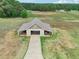 Aerial view of barn with adjacent acreage showing grass and trees at 625 Henderson Mill Rd, Covington, GA 30014