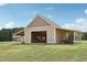 Exterior view of open barn with covered sides showing garage door, lawn equipment and yard at 625 Henderson Mill Rd, Covington, GA 30014