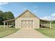 Exterior of barn with closed garage door and equipment stored under carport at 625 Henderson Mill Rd, Covington, GA 30014