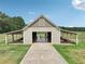 Barn with open garage door and equipment stored under carport at 625 Henderson Mill Rd, Covington, GA 30014