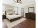 Spacious bedroom with hardwood floors, ceiling fan, neutral walls, and abundant natural light at 625 Henderson Mill Rd, Covington, GA 30014