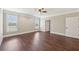 Bedroom with wood floors, ceiling fan, and windows, offering ample space and natural light at 625 Henderson Mill Rd, Covington, GA 30014