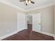 Bedroom featuring wood floors, a ceiling fan and an ensuite entrance at 625 Henderson Mill Rd, Covington, GA 30014