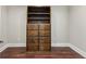 Built-in closet featuring dark wood shelving and drawers, with hardwood floors and modern trim throughout at 625 Henderson Mill Rd, Covington, GA 30014