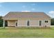 Rear exterior of house with porch and manicured lawn and stone foundation at 625 Henderson Mill Rd, Covington, GA 30014