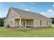 Rear exterior of house with porch and manicured lawn and stone foundation at 625 Henderson Mill Rd, Covington, GA 30014