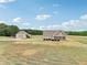 Home and barn-like structure on a large grass lot, providing ample space at 625 Henderson Mill Rd, Covington, GA 30014