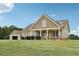 Charming home with a welcoming front porch, attractive landscaping, and a matching detached garage at 625 Henderson Mill Rd, Covington, GA 30014