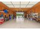 Spacious garage with high ceilings, ample lighting, and organized storage for cars and tools at 625 Henderson Mill Rd, Covington, GA 30014