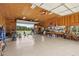 Spacious garage with roll up door and gym equipment and work bench overlooking large acreage at 625 Henderson Mill Rd, Covington, GA 30014
