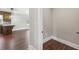 Hallway leading to the open-concept living and kitchen area, featuring gleaming hardwood floors at 625 Henderson Mill Rd, Covington, GA 30014