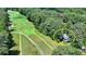 Secluded home nestled beside a golf course and surrounded by lush, mature trees at 945 Tiber Cir, Alpharetta, GA 30022