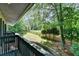 Backyard view of the tree lined fenced in yard from the patio at 945 Tiber Cir, Alpharetta, GA 30022