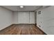 Large basement with wood laminate flooring, storage closet, and access to outdoors at 945 Tiber Cir, Alpharetta, GA 30022