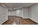 Spacious basement with wood laminate flooring and bright, white walls at 945 Tiber Cir, Alpharetta, GA 30022