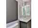 Bathroom with modern vanity and a window view at 945 Tiber Cir, Alpharetta, GA 30022