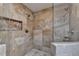 Walk-in shower with dual shower heads, stone tile, and glass door at 945 Tiber Cir, Alpharetta, GA 30022
