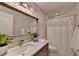 Bathroom features stylish mirror, vanity with quartz countertop, and shower-tub combo at 945 Tiber Cir, Alpharetta, GA 30022