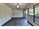 Empty bedroom with dark hardwood floors, a window with natural light, white closet doors and neutral walls at 945 Tiber Cir, Alpharetta, GA 30022