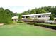 Well-maintained building exterior with ample parking and beautiful landscaping at 945 Tiber Cir, Alpharetta, GA 30022
