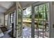 View from inside featuring open French doors leading to a relaxing outdoor deck at 945 Tiber Cir, Alpharetta, GA 30022