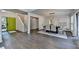 Open-concept space with view of bright green front door, dining area with stylish lighting, and hardwood floors at 945 Tiber Cir, Alpharetta, GA 30022