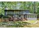 Back exterior of home showcasing the deck, balcony, screened in porch, and backyard at 945 Tiber Cir, Alpharetta, GA 30022