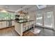 Modern kitchen featuring stainless steel appliances, black countertops, and natural light from large windows at 945 Tiber Cir, Alpharetta, GA 30022