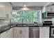 Modern kitchen with stainless steel appliances, sleek countertops, and natural lighting for an inviting cooking space at 945 Tiber Cir, Alpharetta, GA 30022